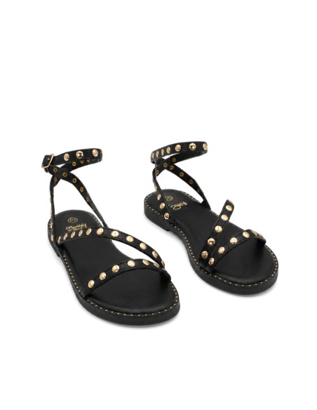 Sandalia infantil negra con detalles dorados.