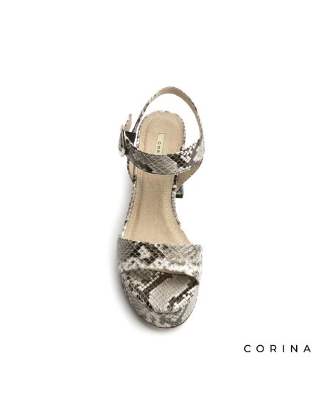 Vista frontal de sandalias serpiente de tacón ancho para mujer