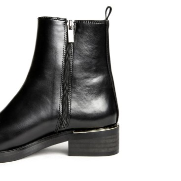 Detalle cremallera y pieza metálica talón botín negro